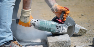 Worker cutting granite.
