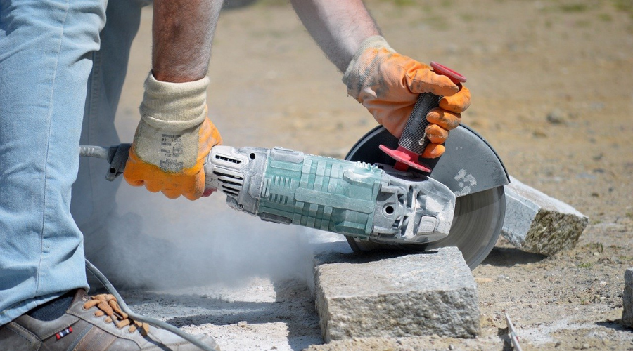 Worker cutting granite.